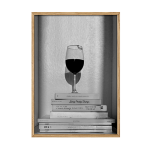 Wine or books. Et rødvinsglas med læbeaftryk på en tabel bøger.